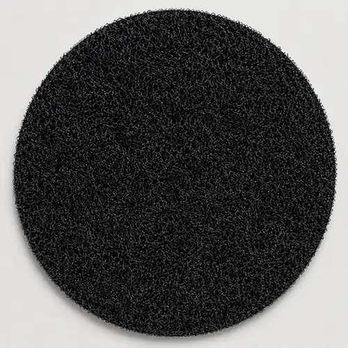 Back view of a custom round embroidered patch with black hook-and-loop fabric for removable attachment.