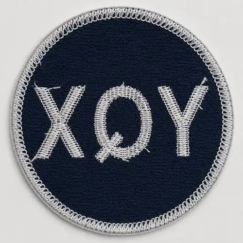 Back view of a custom round sew-on embroidered patch with white bobbin stitching and no adhesive backing.