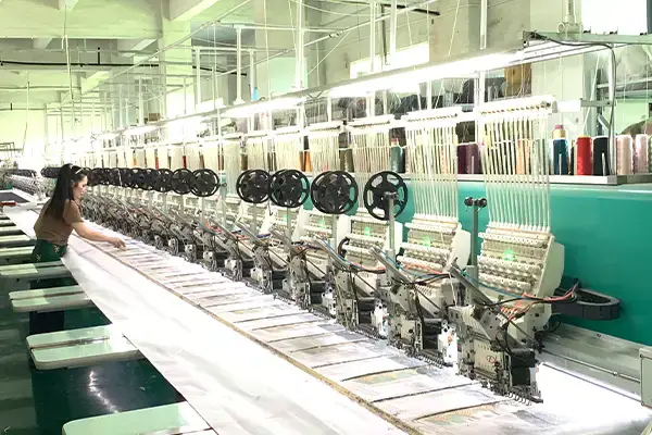 Computerized embroidery machines processing fabric panels for bulk precision embroidery production.