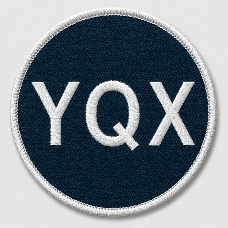 Front view of a round custom embroidered patch with white lettering and a finished white merrowed edge.