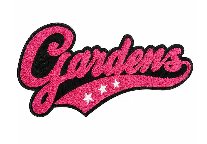 Custom chenille patch with pink “Gardens” script lettering, black detailing, and three white embroidered stars.