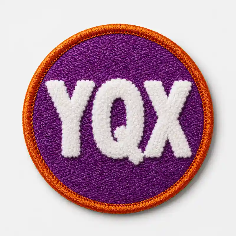 Round purple patch with white chenille YQX lettering and a reinforced orange merrowed border
