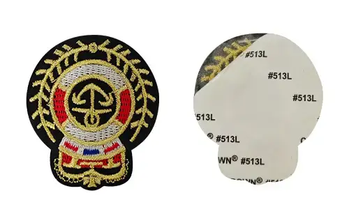 Front and back view of an embroidered patch with self-adhesive backing for temporary placement, sample checking, displays, or short-term branding.