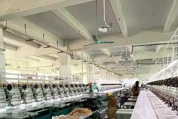 YQX computerized embroidery factory with production lines supporting sampling and bulk embroidery manufacturing for international B2B customers.