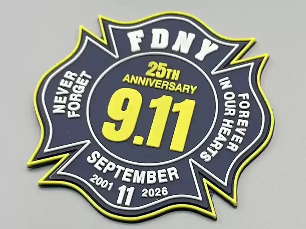 Custom PVC patch with raised lettering, bold colors, and a flexible rubber-like surface.