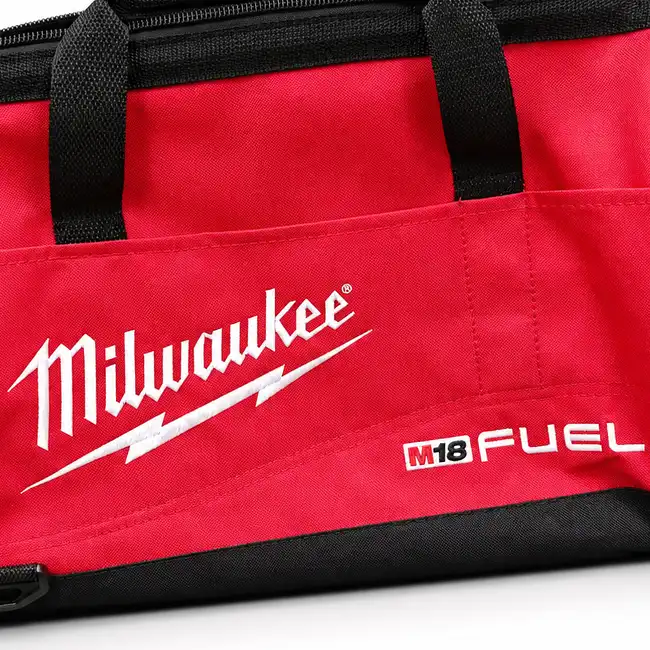 White flat embroidery logo and text stitched on a red handbag panel with black trim and handles.