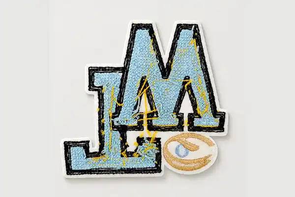 Custom embroidered patch with no backing, showing the flexible patch construction designed for direct sewing onto garments, bags, and textile products.